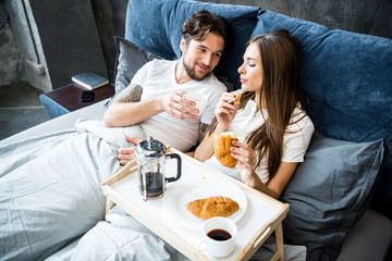 Couple has breakfast in bed
