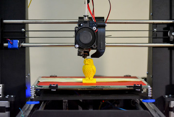 Modern 3D printer printing figure close-up. Automatic three dimensional 3d printer performs plastic...