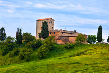 Fototapeta na wymiar Big stone farmer house on the green hill, Tuscany, Italy