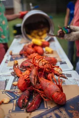 Zelfklevend Fotobehang Lobsters laid out on table for Lobster Boil dinner © The Outdoor Kids