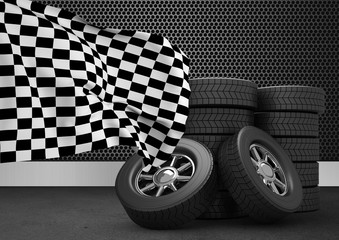 Stack of tires with checkered flag against black background