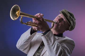 Portrait image of a mature jazz man playing the trumpet