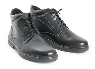 Pair of black mens leather winter boots isolated on a white background