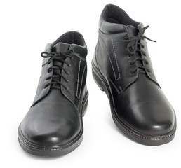Pair of black mens leather winter boots isolated on a white background