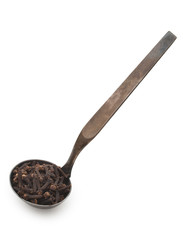 Vintage silverware, Very old dark rusted ladle, scoop with spices, carnation, clove, isolated on a white, close up.