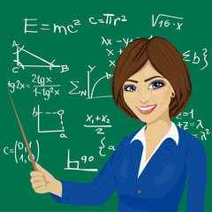 young math teacher standing next to blackboard