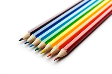 Colored pencils arranged in rainbow spectrum order isolated on white background
