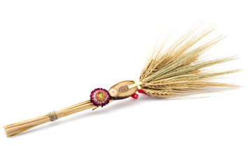 Beautiful wheat bouquet with red ribbon, slice of wood, dry flower and wooden cross, isolated on white. Bozic, Serbian ortodox christmas