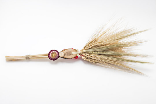 Beautiful wheat bouquet with red ribbon, slice of wood, dry flower and wooden cross, isolated on white. Bozic, Serbian ortodox christmas