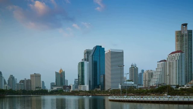 4K. Time lapse View of Business Building Bangkok city asia Thailand and lake with transportation road and sky, day to night twilight. Transportation concept