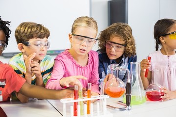 Kids doing a chemical experiment in laboratory