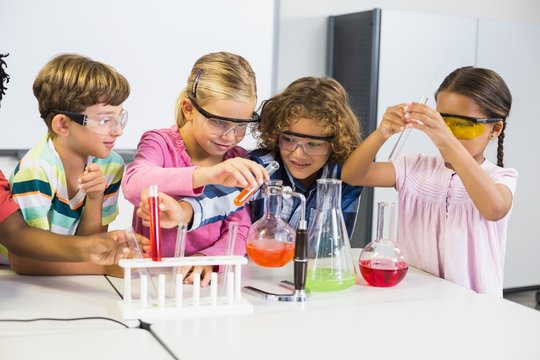 Kids doing a chemical experiment in laboratory