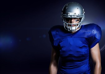American football player standing against blue background
