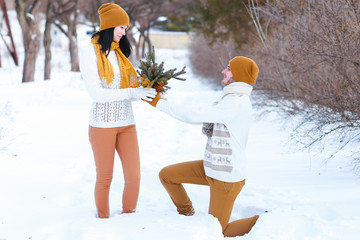 Portrait of young couple boyfriend present flowers as gift to gi