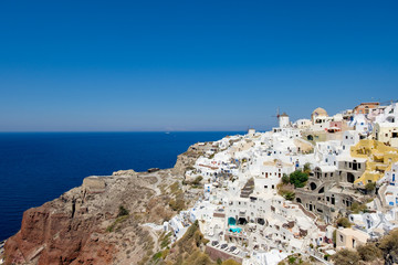 Fototapeta na wymiar view with traditional white buildings over the village of Oia