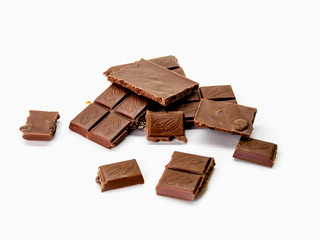 milk chocolate with broken isolated on a chalk background