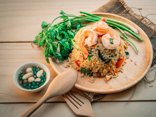 Vintage style Traditional Thai food Fried rice with shrimp on top able plan on wooden background wallpaper
