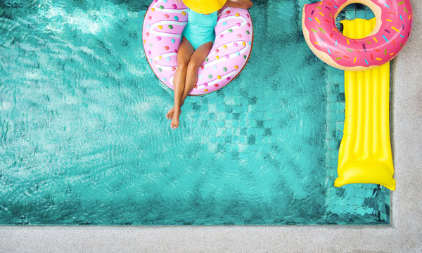 Woman relaxing on inflatable ring in pool