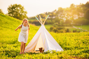 Young happy kid girl dancing outside, school girl playing outdoors on a nice warm evening at...