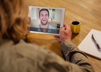 Woman having a video call with her friend on digital tablet
