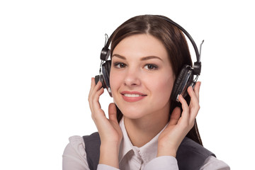 Happy young woman listening to music via headphones