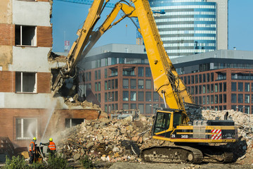 Demolitions old building in center city with heavy equipment