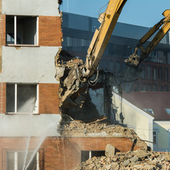 Demolitions old building in center city with heavy equipment