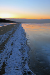 On coast of Gulf of Riga in winter evening. Jurmala, Latvia