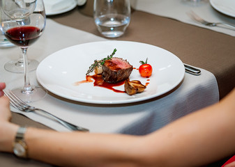 Delicious grilled steak on plate with glass of wine