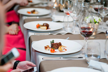 Delicious grilled steak on plate with glass of wine