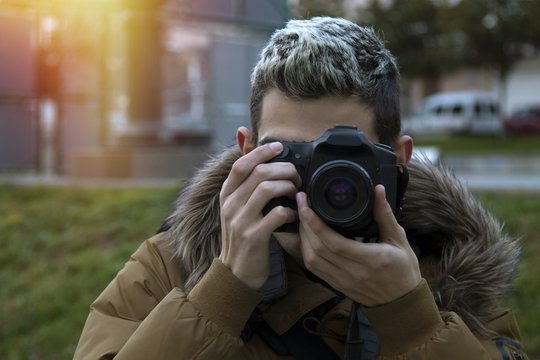 photographer, young boy teen taking pictures with the camera