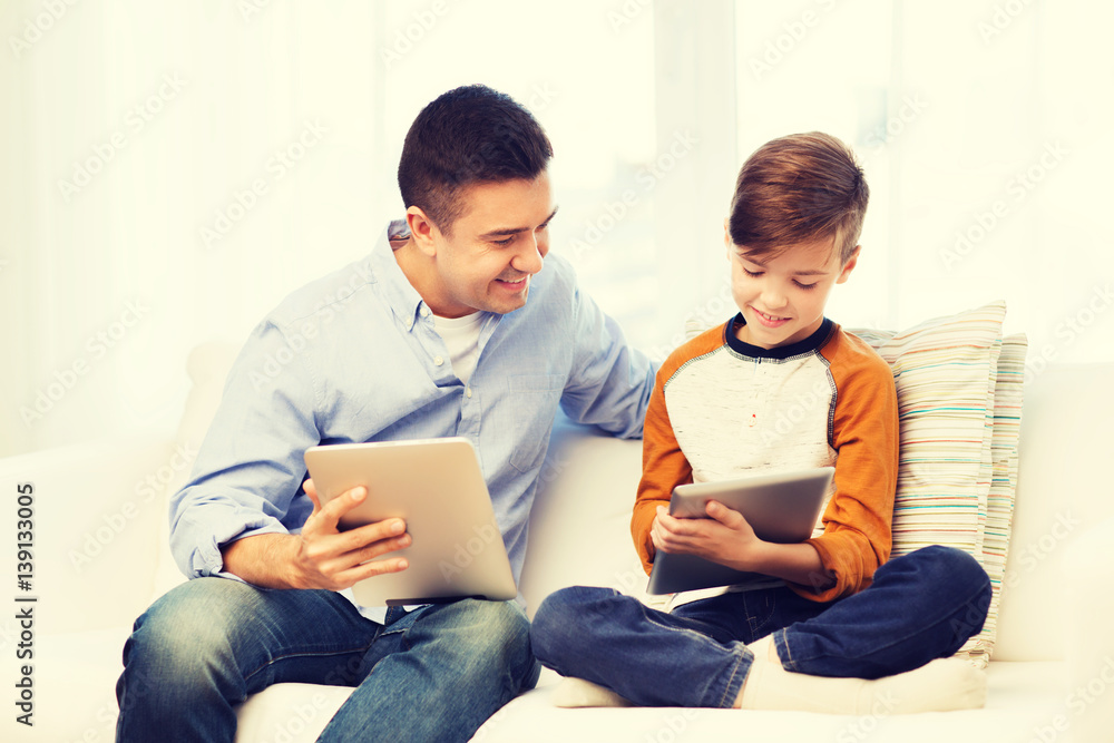 Poster happy father and son with tablet pc at home