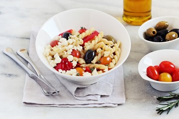 Pasta salad with fresh vegetables and feta cheese. Selective focus