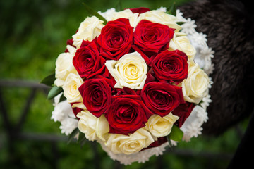 wedding bouquet from roses on a green background