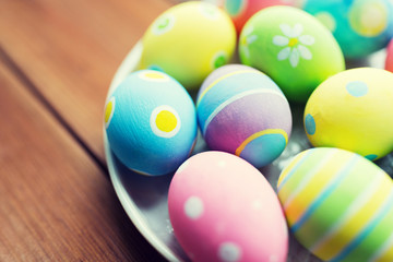 close up of colored easter eggs on plate