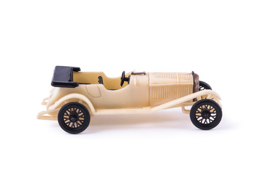 Vintage, old, plastic car toy on the white isolated background.