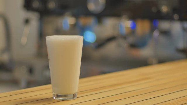 Close-up - the barman prepares a latte in fast shooting