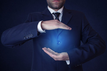 Businessman with cupped hands as if holding something.