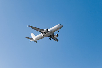 Fototapeta na wymiar white airplane on a blue background. airplane in the sky