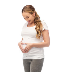 happy pregnant woman showing heart gesture