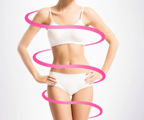 Fototapeta premium Close-up of thin and beautiful female body. Weight loss, fat burn, sports, exercising concept. Red arrows.