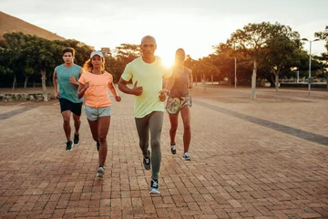 Papier Peint photo Lavable Jogging Group running outdoors in evening