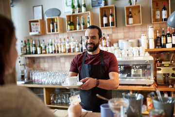 man or waiter serving customer at coffee shop