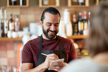 man or waiter serving customer at bar