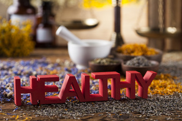 Healthy herbs on wooden table, mortar and herbal medicine