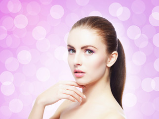 Naklejka premium Portrait of young, beautiful and healthy woman: over pink background. Healthcare, spa, makeup and face lifting concept.