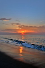 Fototapeta premium Golden and Glowing Sunrise at the Shore