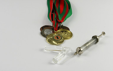 Concept of doping in sport - deprivation medals top view. Place for your text.