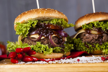 Home made burgers on wooden background
