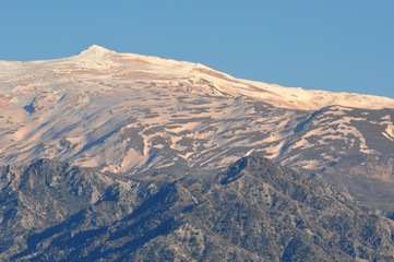 snowy summits colored by the dust of the Sahara desert